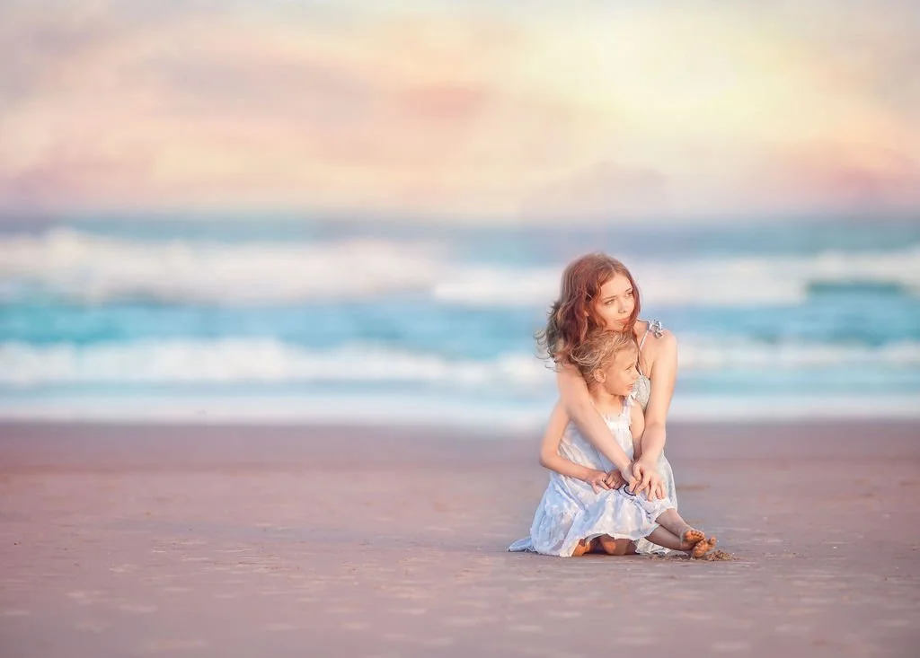 Sisters embracing on the beach in Wildwood New Jersey at sunset