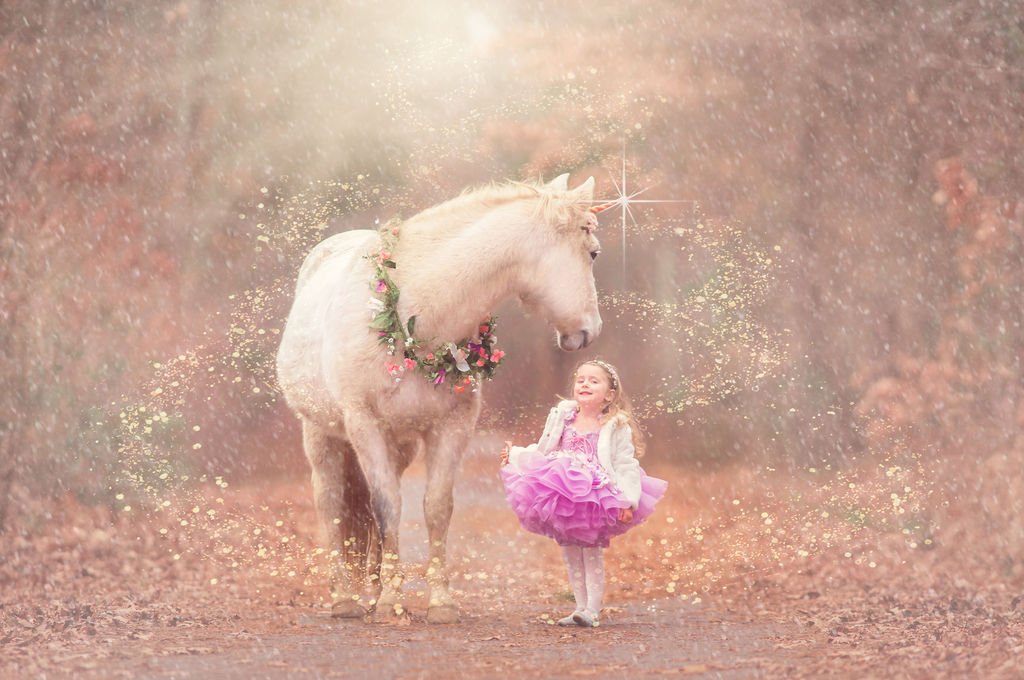 young girl posing with the unicorn Drifter during a magical portrait session in New Jersey