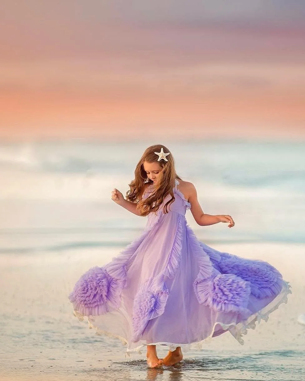 Barefoot in the tide.
Salt in the air.
A dress catching the wind like it knows childhood never stays still.

These are the little in-between moments parents don&rsquo;t realize they&rsquo;ll miss someday &hellip; the spinning, the splashing, the free