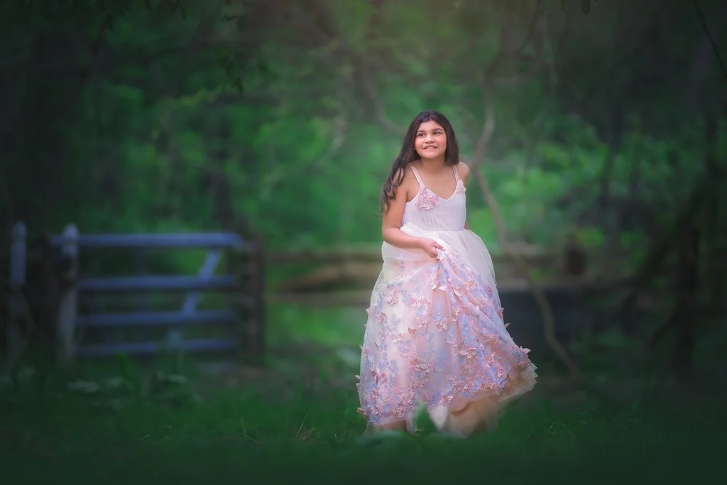 Girl twirling in a butterfly dress during a magical birthday portrait session in Mullica Hill New Jersey photographed by a South Jersey children’s photographer.