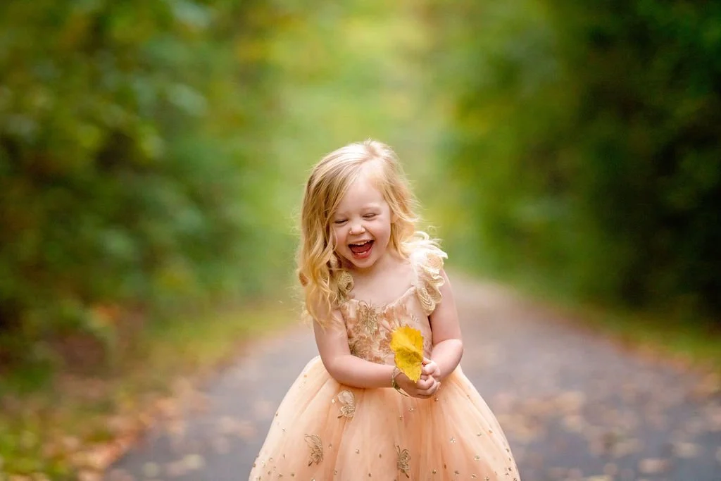 Closeup portrait of a laughing young girl during a family maternity photography session in South Jersey.