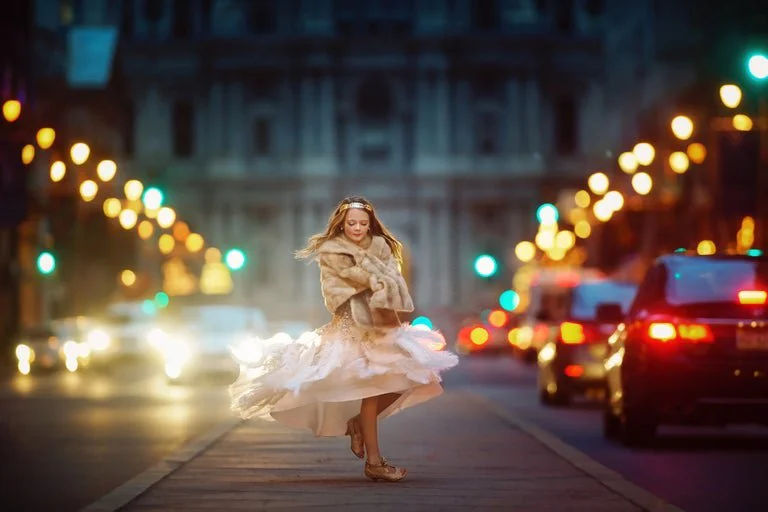A cinematic child portrait near Philadelphia City Hall, capturing movement, light, and storybook energy in an iconic urban setting.