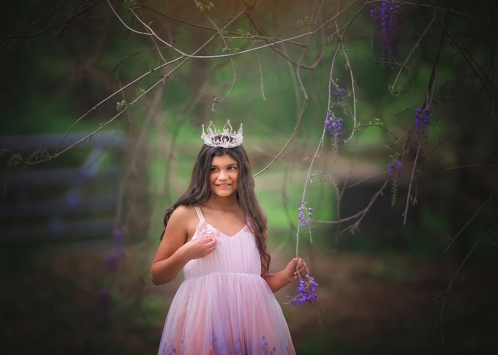 Closeup portrait of a girl with wisteria flowers during a birthday photoshoot in Mullica Hill New Jersey photographed by a South Jersey children’s photographer.