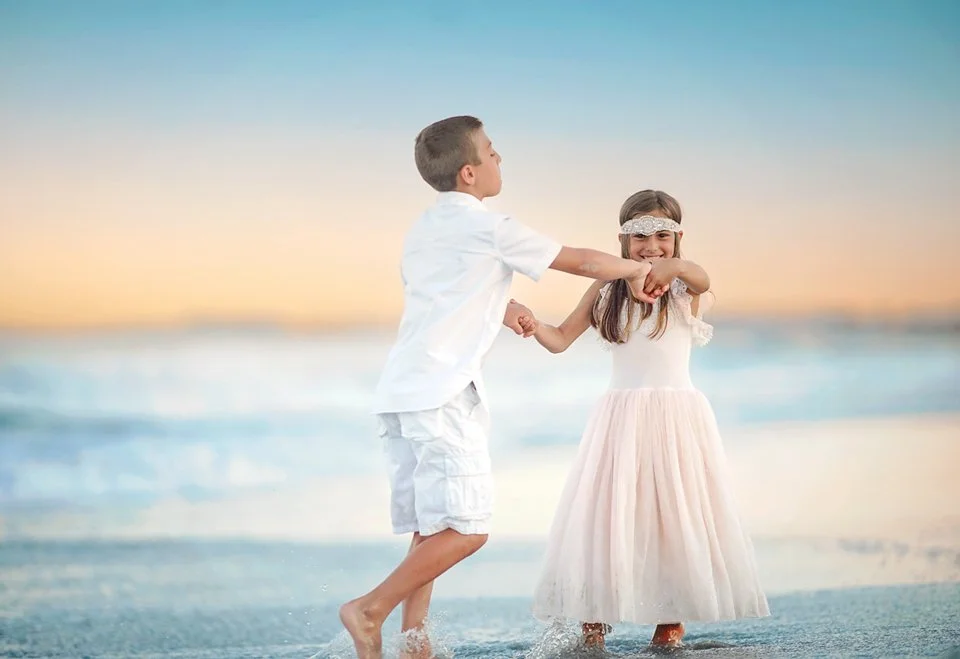 Brother and sister playing by the ocean during a family photography session in Ocean City NJ