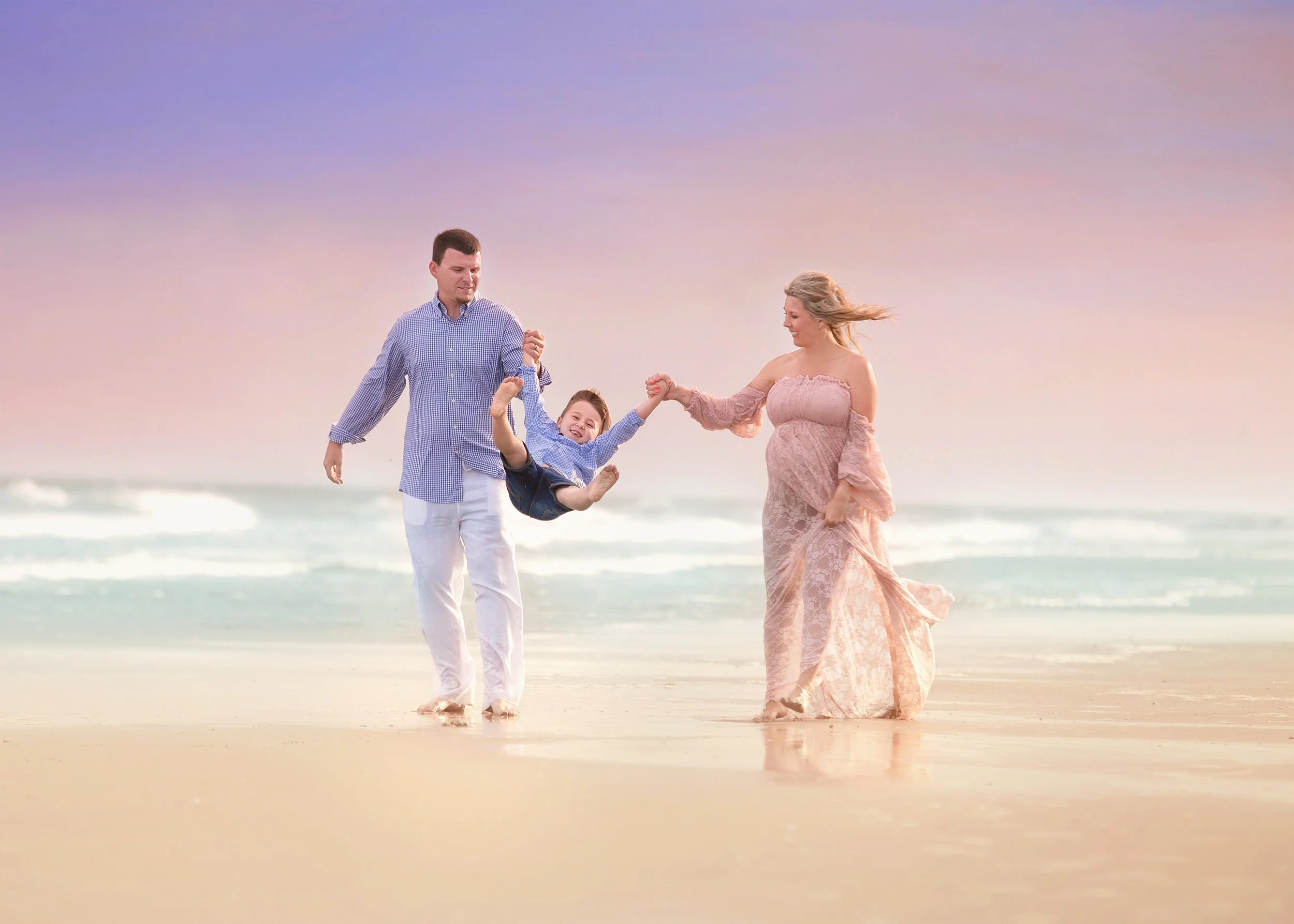 Family standing together near the shoreline during a Jersey Shore beach portrait session