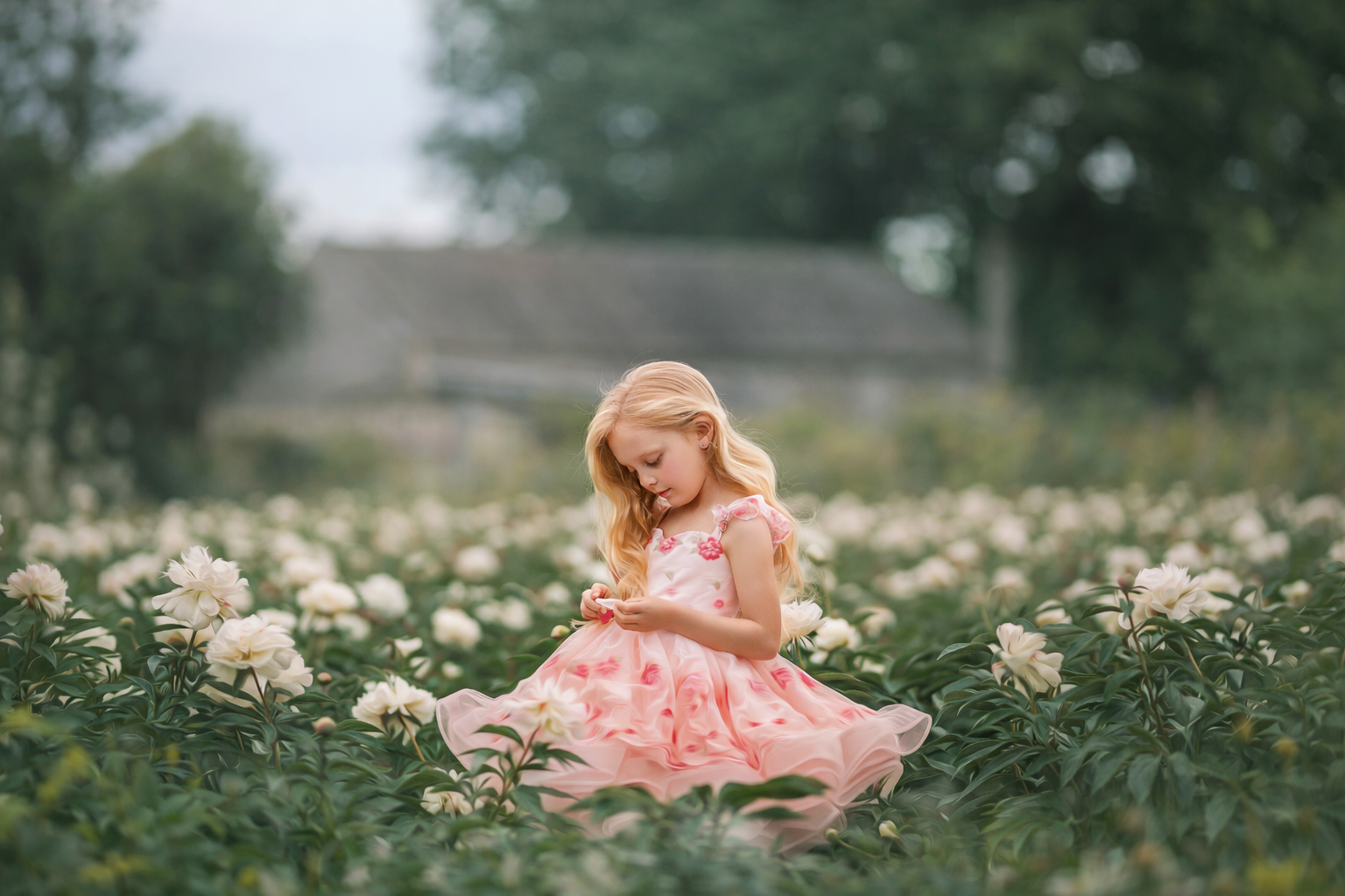 Girl in a pink dress standing in a peony field during spring, photographed by a New Jersey family photographer.