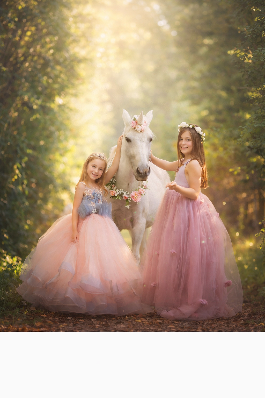 Two young girls in flowing pink dresses gently standing beside a real unicorn during a fine art unicorn portrait session in South Jersey, photographed in soft golden woodland light