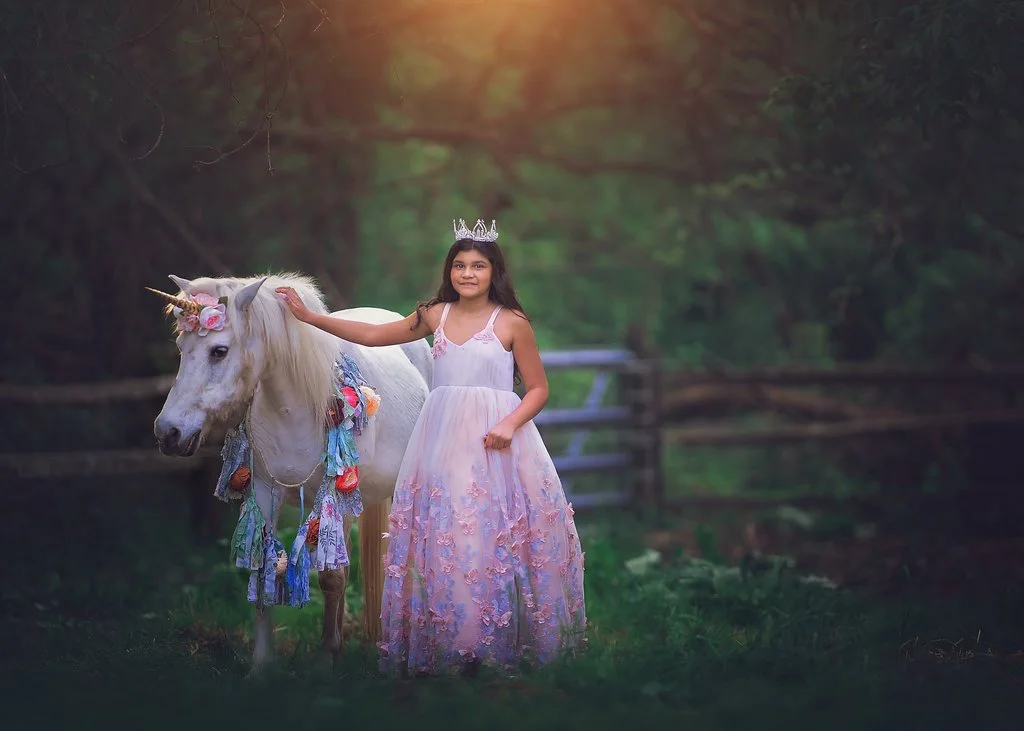 Birthday girl standing with a unicorn during a children’s portrait session in Mullica Hill NJ captured by a New Jersey photographer.