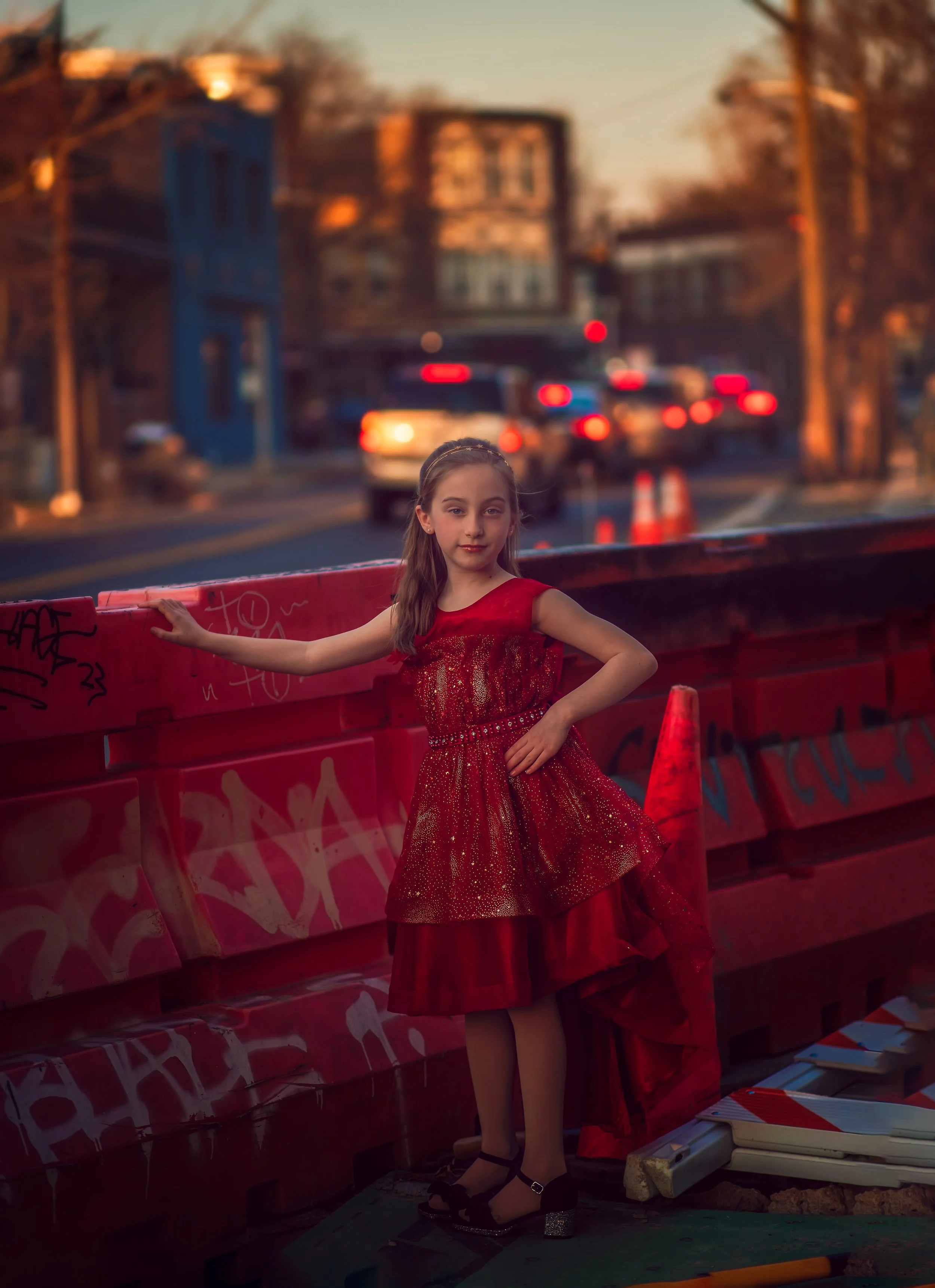 Natural light child portrait in Collingswood NJ of girl in red dress looking at camera downtown