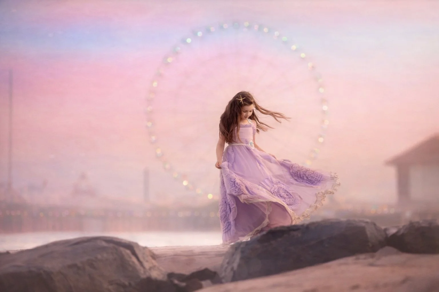 Young girl in a purple dress photographed near the Ferris wheel in Atlantic City, New Jersey, during a fine art child portrait session at sunset