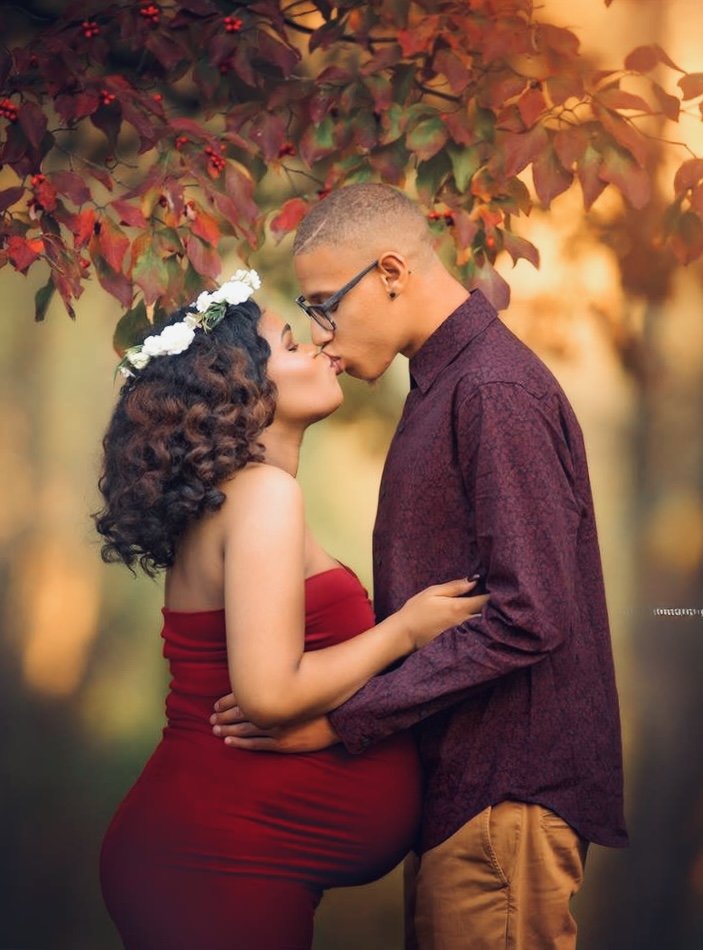 couple sharing a kiss during a romantic portrait session at a park in Pennsylvania