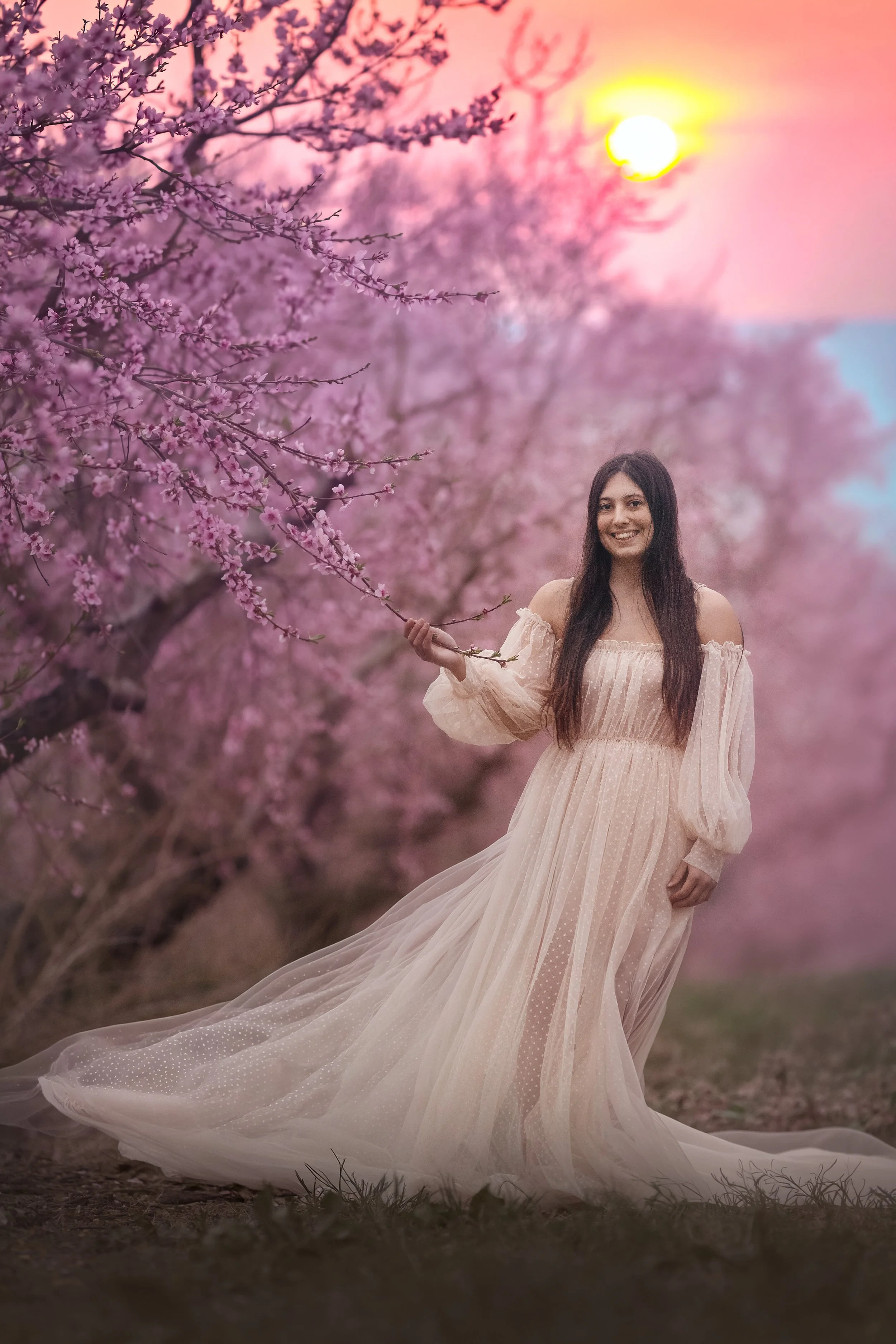 Teen in a peach blossom orchard at sunset during a spring session with a New Jersey family photographer.