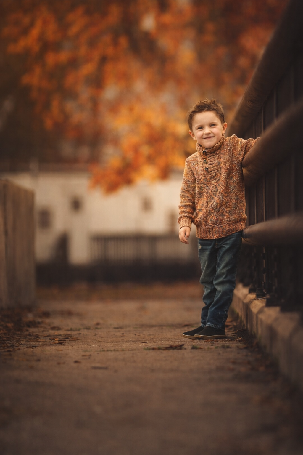 Toddler laughing and posing on a wooden bridge during a Philadelphia portrait session