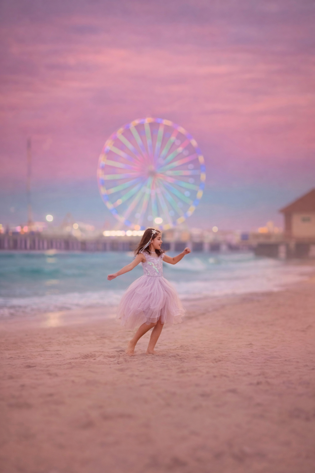 Girl dancing on the beach in Atlantic City during a mini session with the pier in the background at sunset