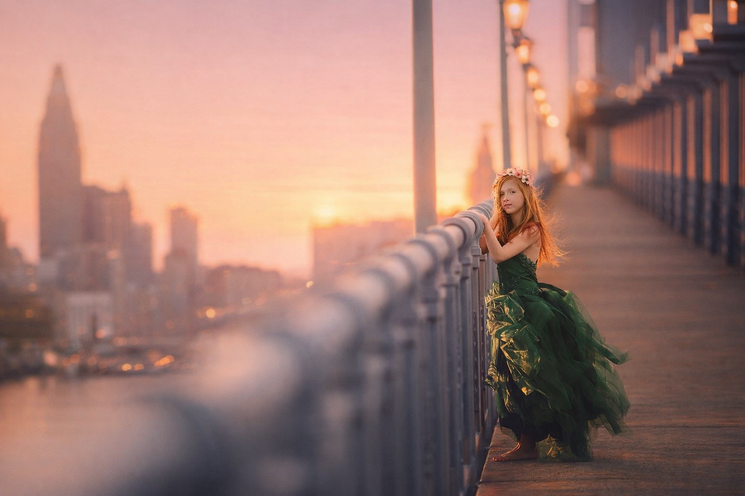 Fine art princess portrait of a young girl in a green gown at sunset on a Philadelphia bridge