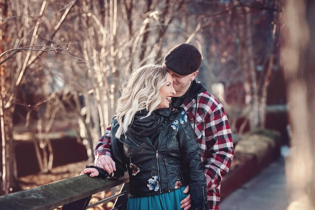An intimate moment during a winter engagement session at Race Street Pier, with Beth smiling softly