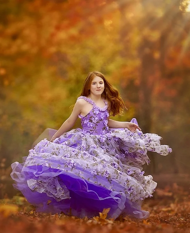 Girl twirling in a purple dress during a fall family photography session in Haddon Heights NJ