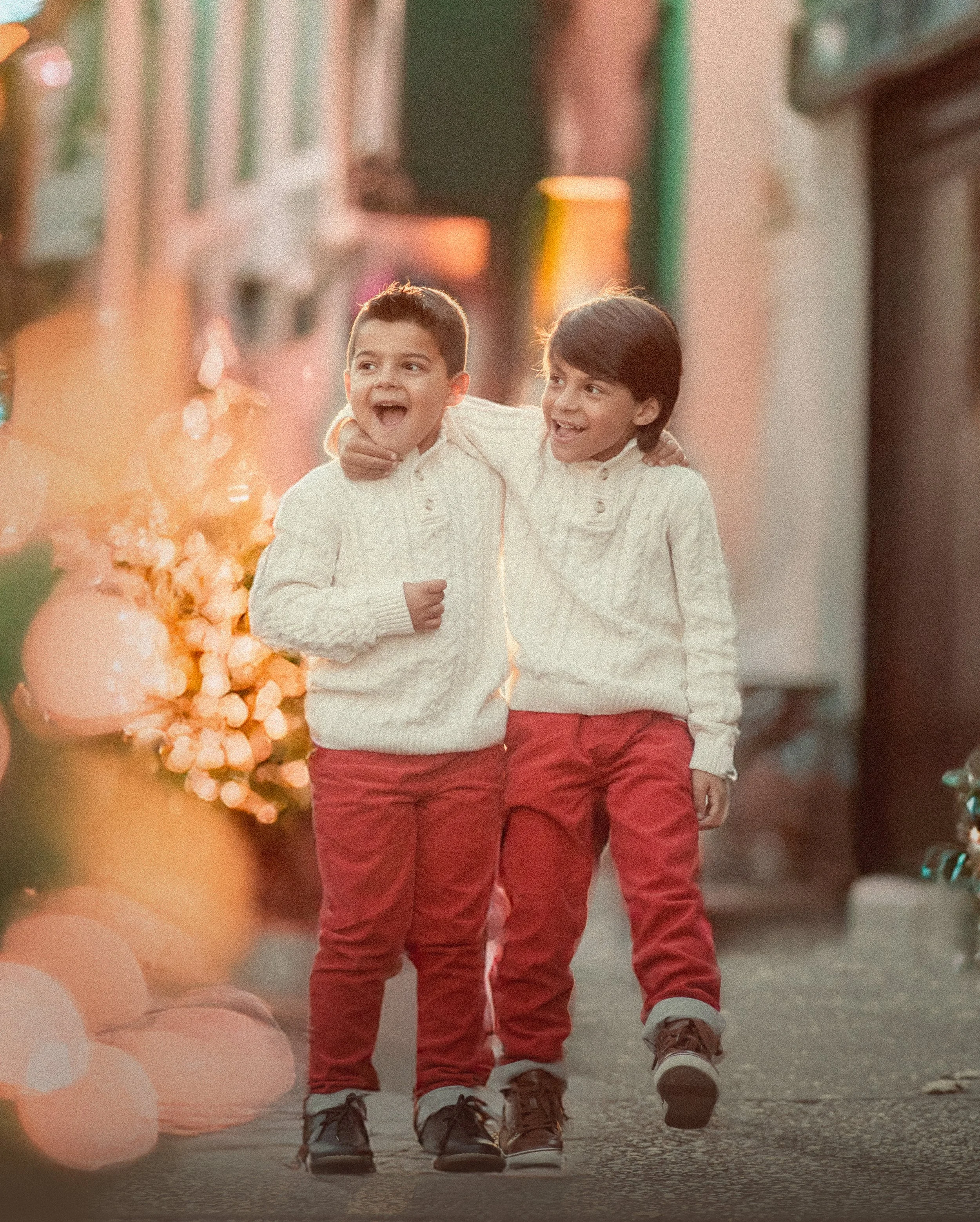 Two young boys walking together during a winter fine art portrait session with soft holiday light and classic styling
