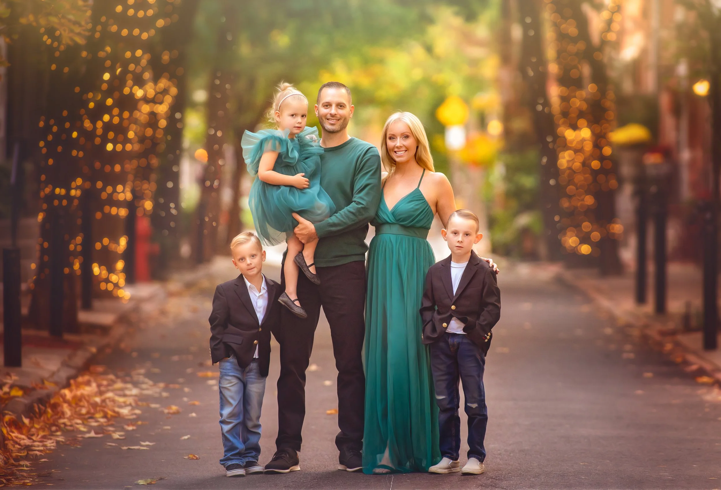 A warm, connected family portrait photographed on a softly lit Philadelphia street, capturing natural connection and relaxed togetherness in an urban setting.