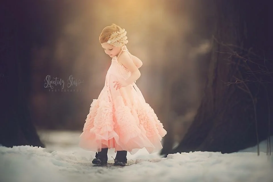 Young girl in an elegant dress during a winter fine art portrait session with warm, minimal styling