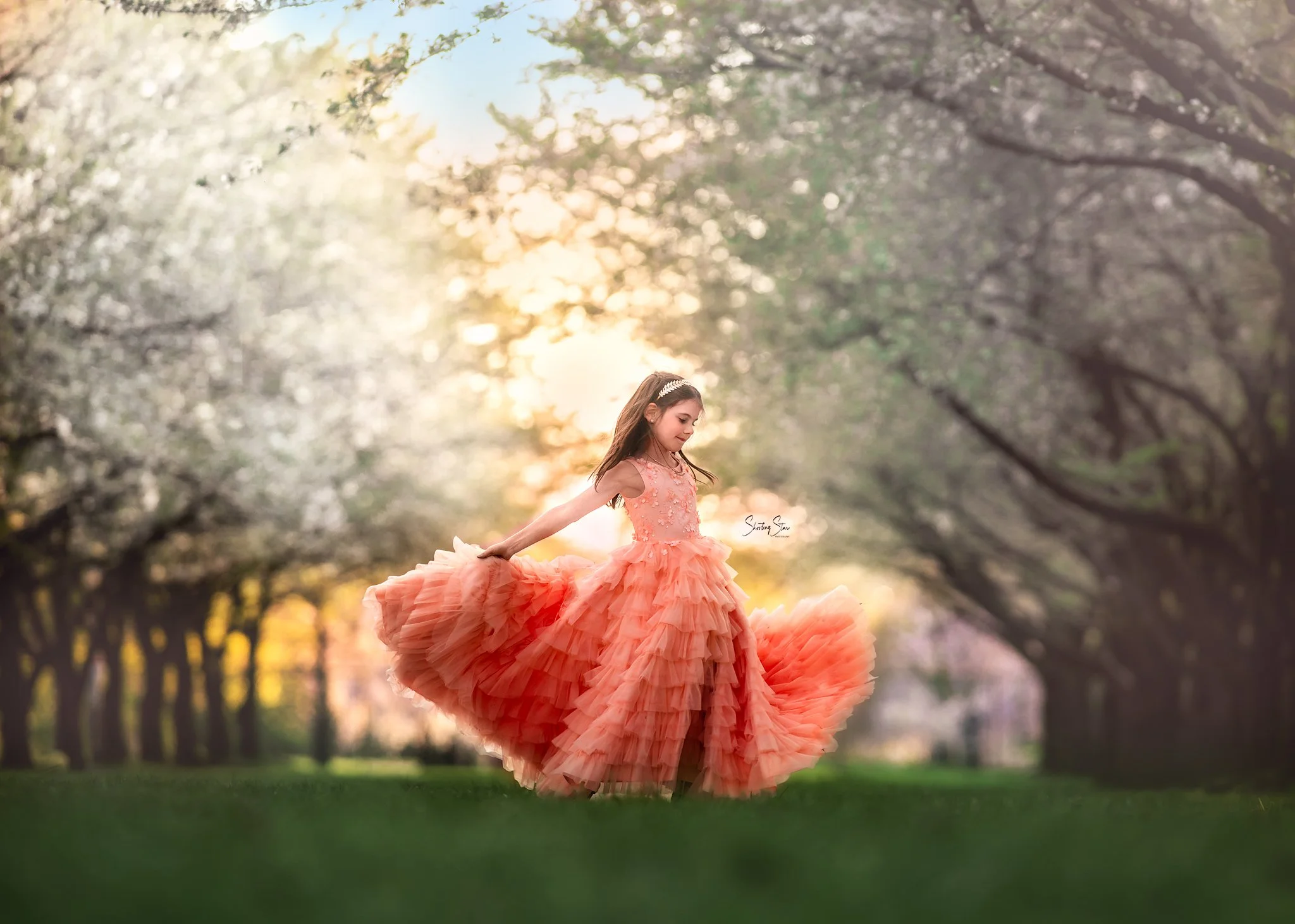 girl twirling among the cherry trees in fairmount park, Philadelphia for a portrait session