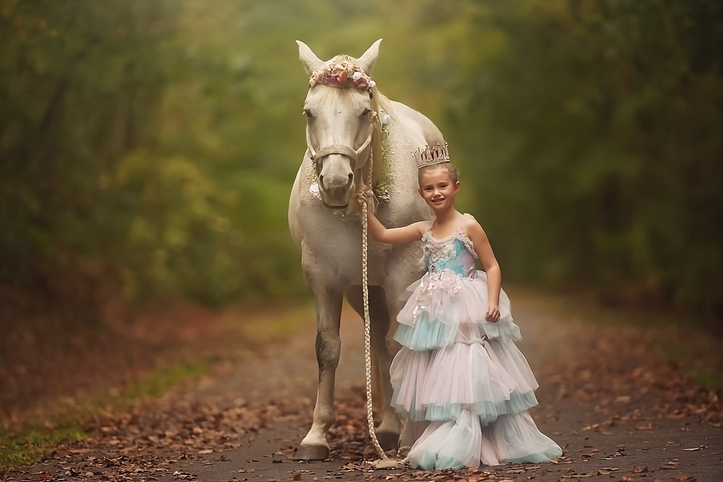 Girl smiling beside a unicorn during a South Jersey unicorn portrait session