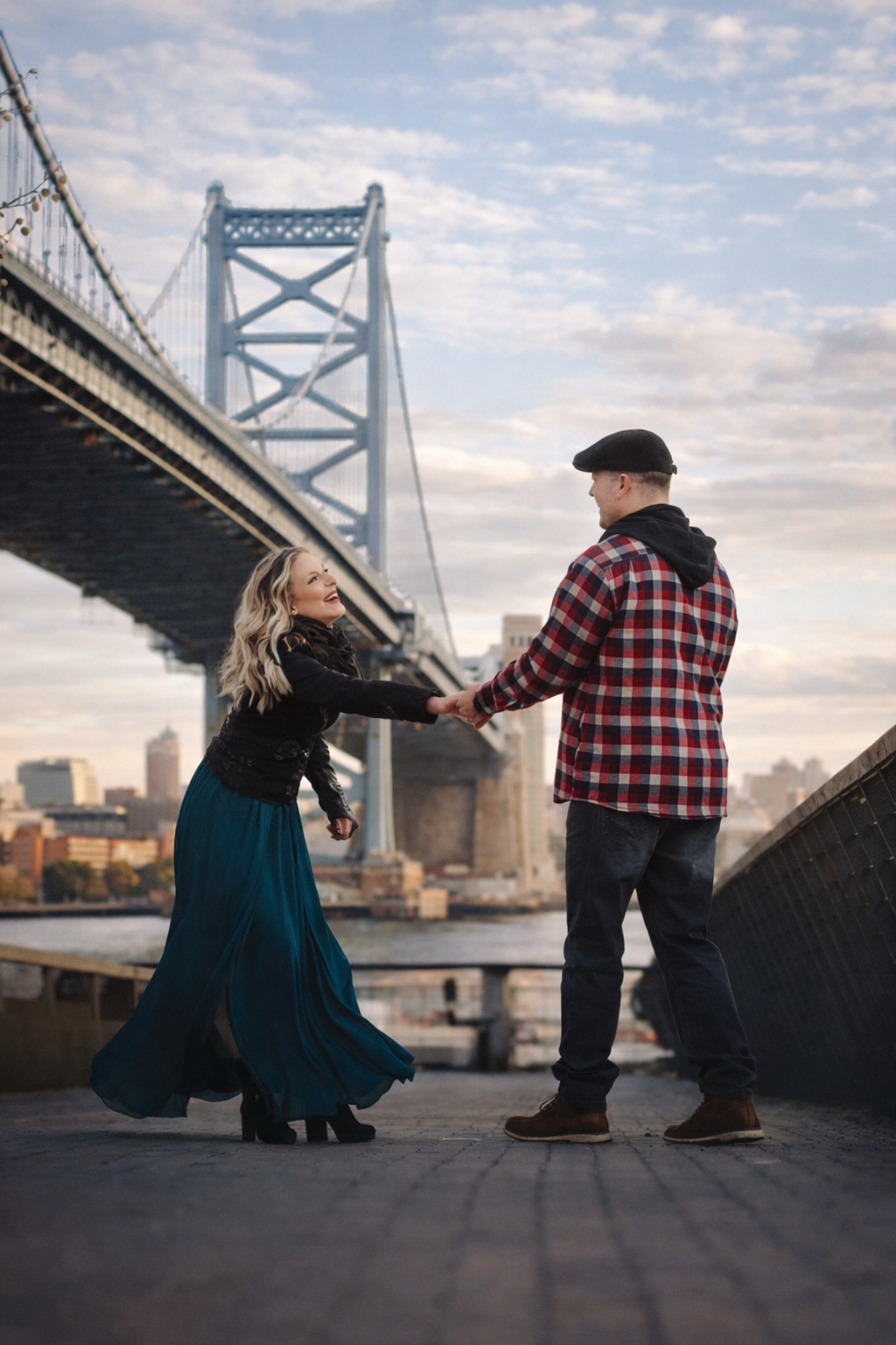 couple dancing on race street pier bridge for an epic engagement session in philadelphia