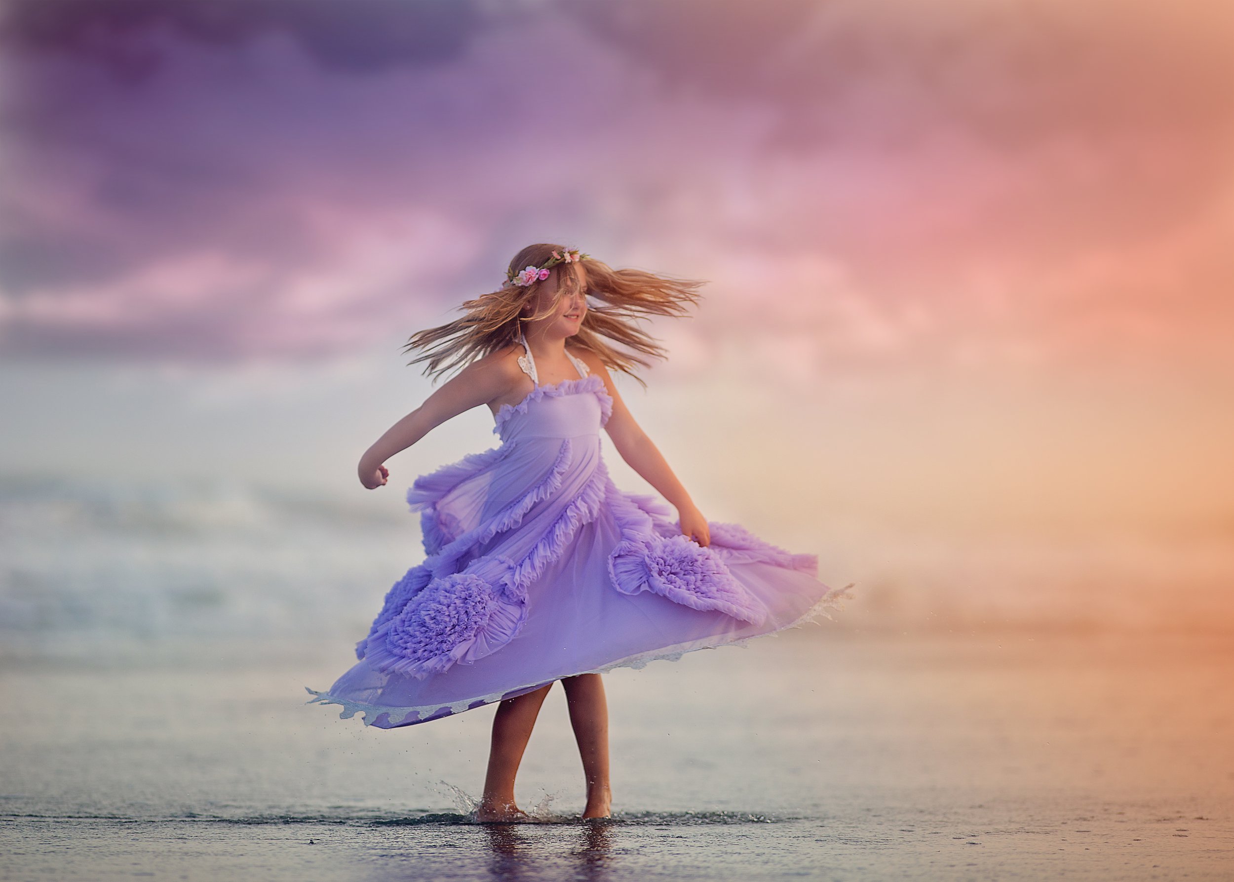 young girl twirling in a dress during a family mini session on the beach in New Jersey and Philadelphia