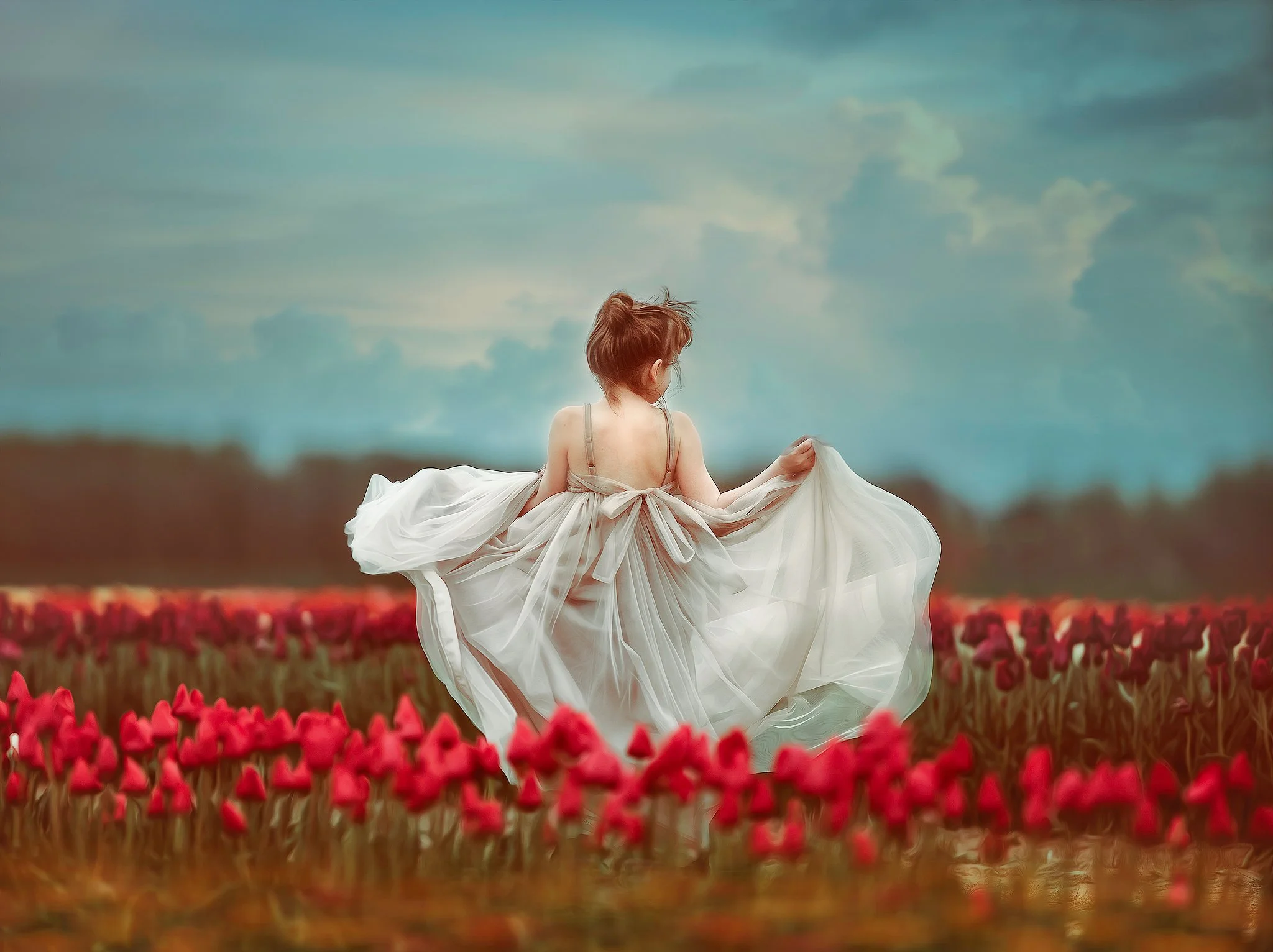 Portrait of a girl in a gray dress standing in a tulip field in New Jersey