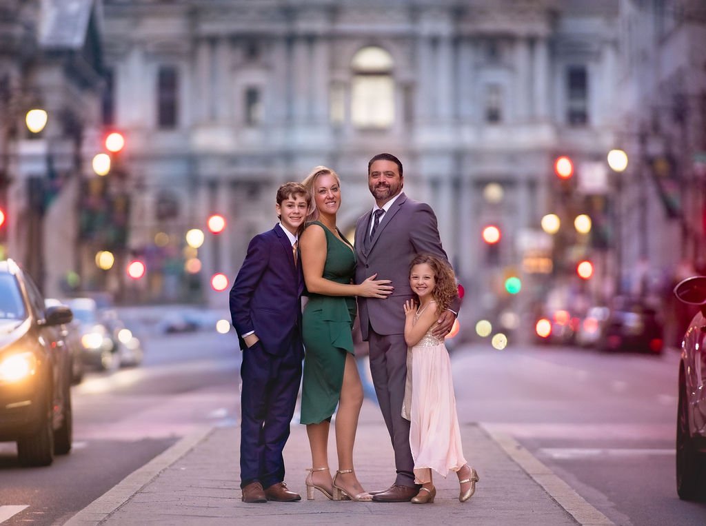 Family portrait during golden hour in Center City Philadelphia with soft evening city light