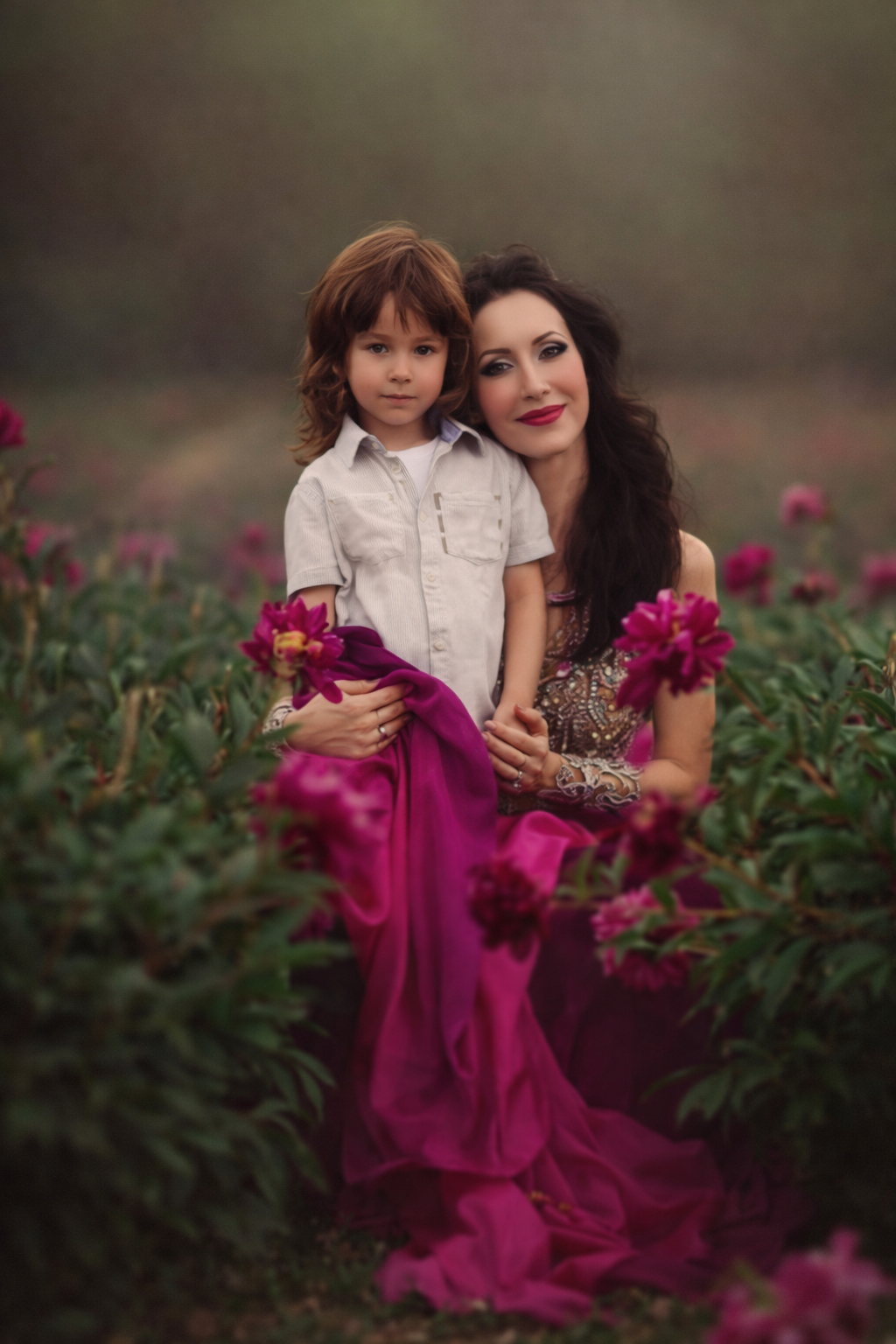 Mother and young son sharing a quiet moment in a blooming peony field during a spring family portrait session in New Jersey