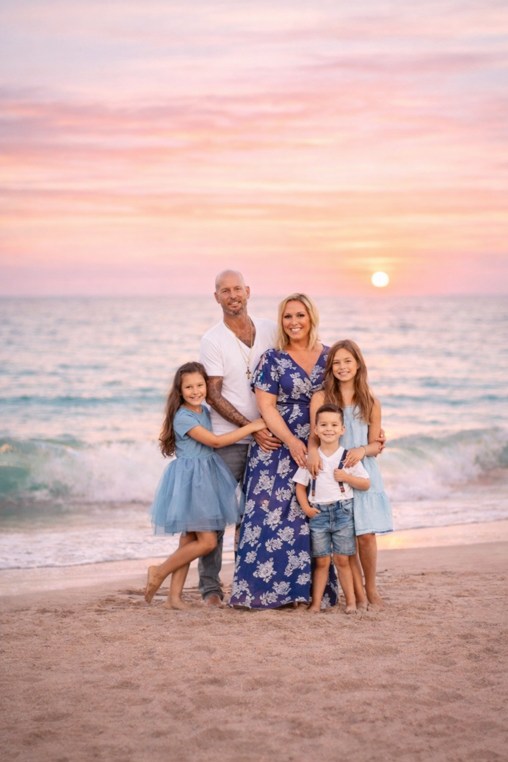 Family standing together on the beach at sunset during a New Jersey family photography session by the ocean