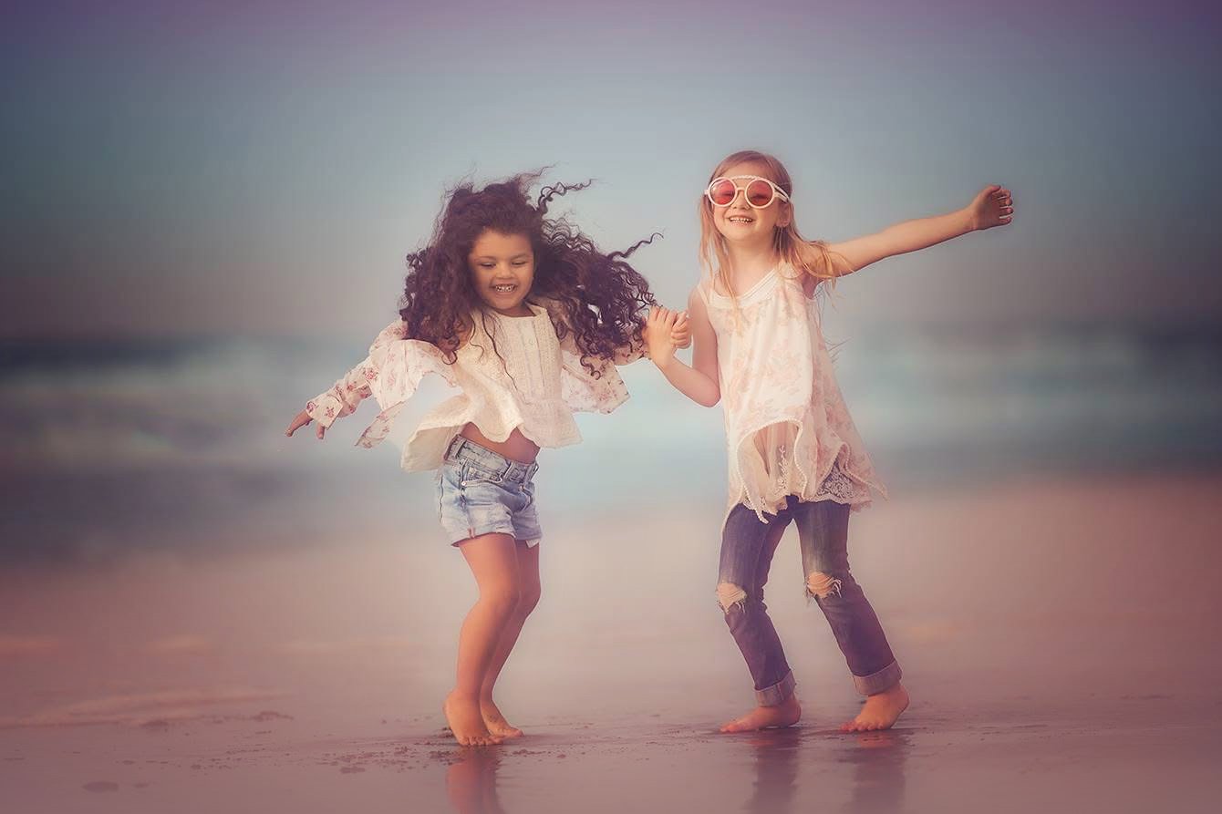 Soft and airy beach photo of two children on the beach in Cape May NJ