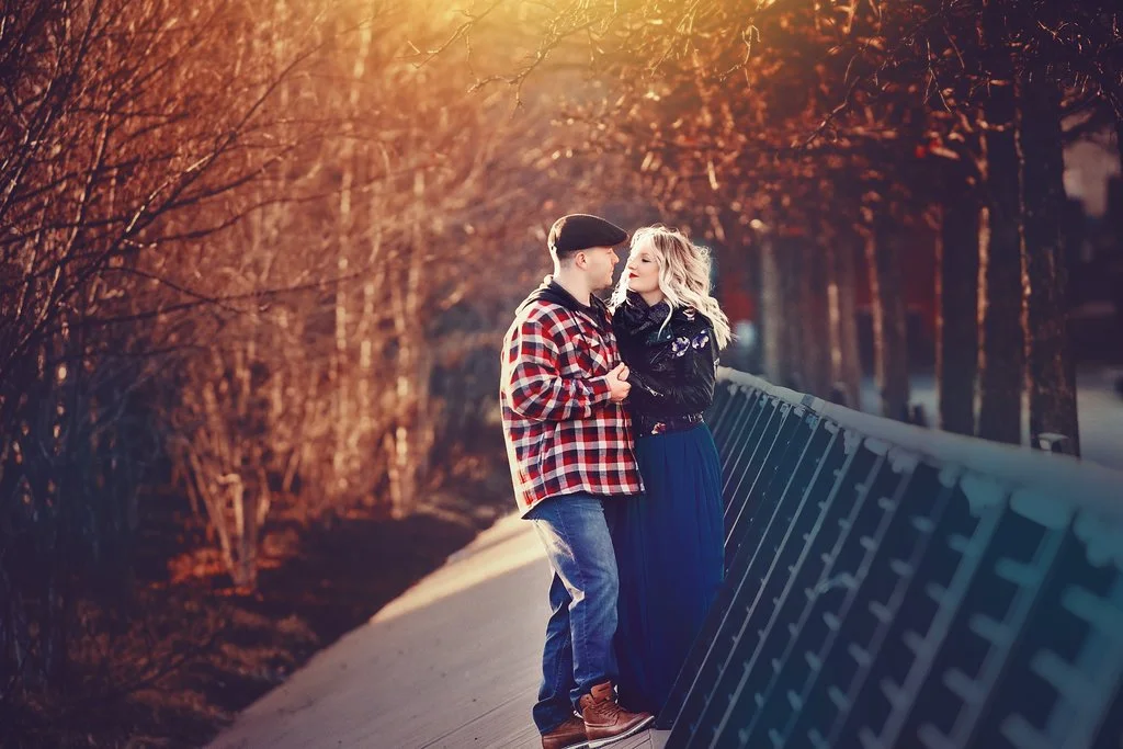 Engaged couple looking at each other at the end of Race Street Pier, surrounded by strong architectural elements