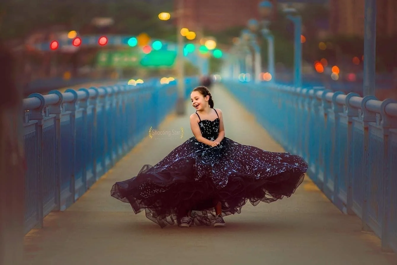 Young girl laughing and twirling in a fine art bridge portrait session in Philadelphia by Shooting Star Photography