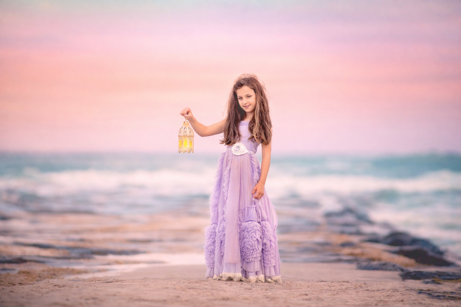girl in a purple dress holding a lantern on the beach at sunset in Ocean City New Jersey