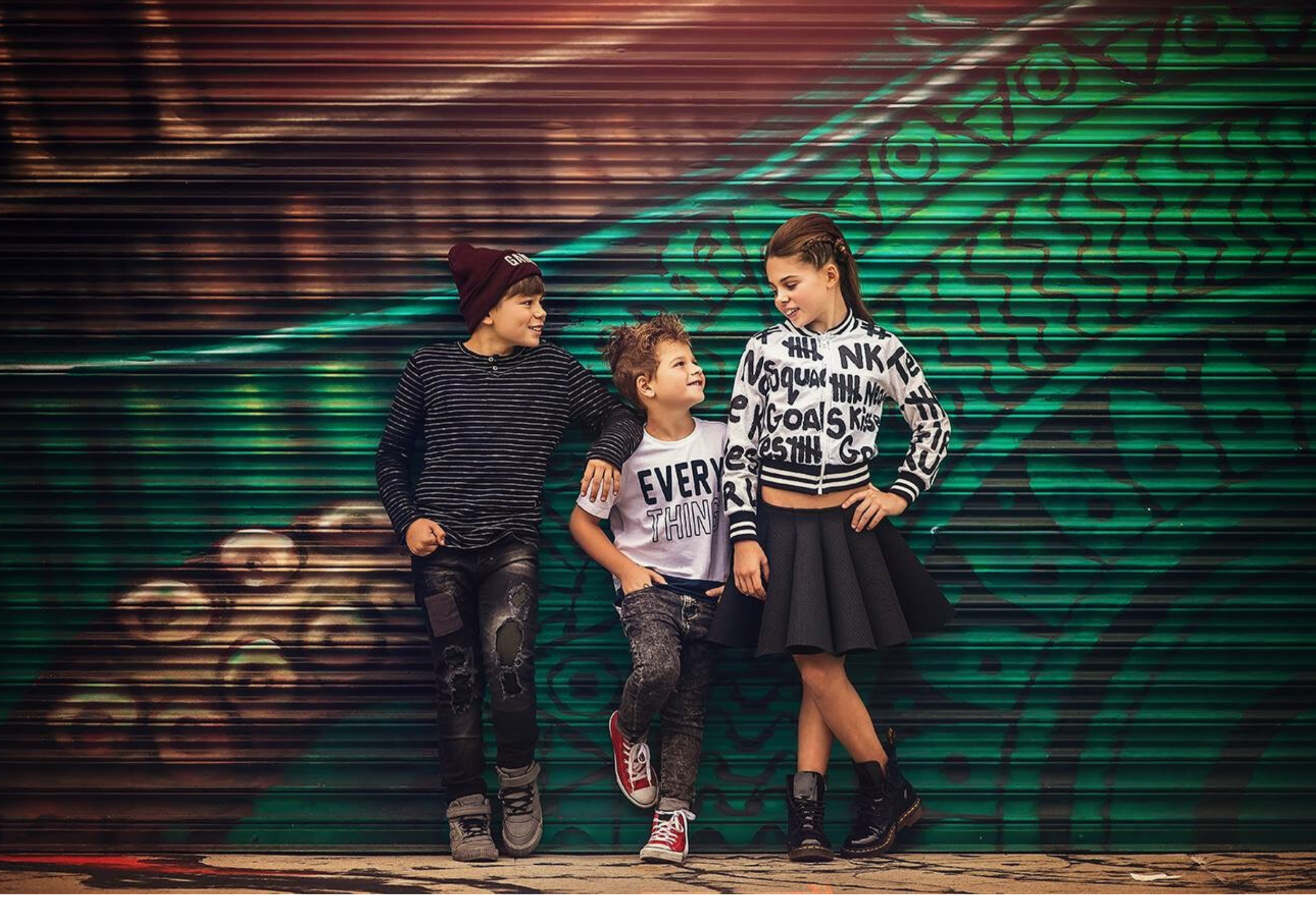 three children walking together during an urban fine art portrait session by a South Jersey children and family photographer