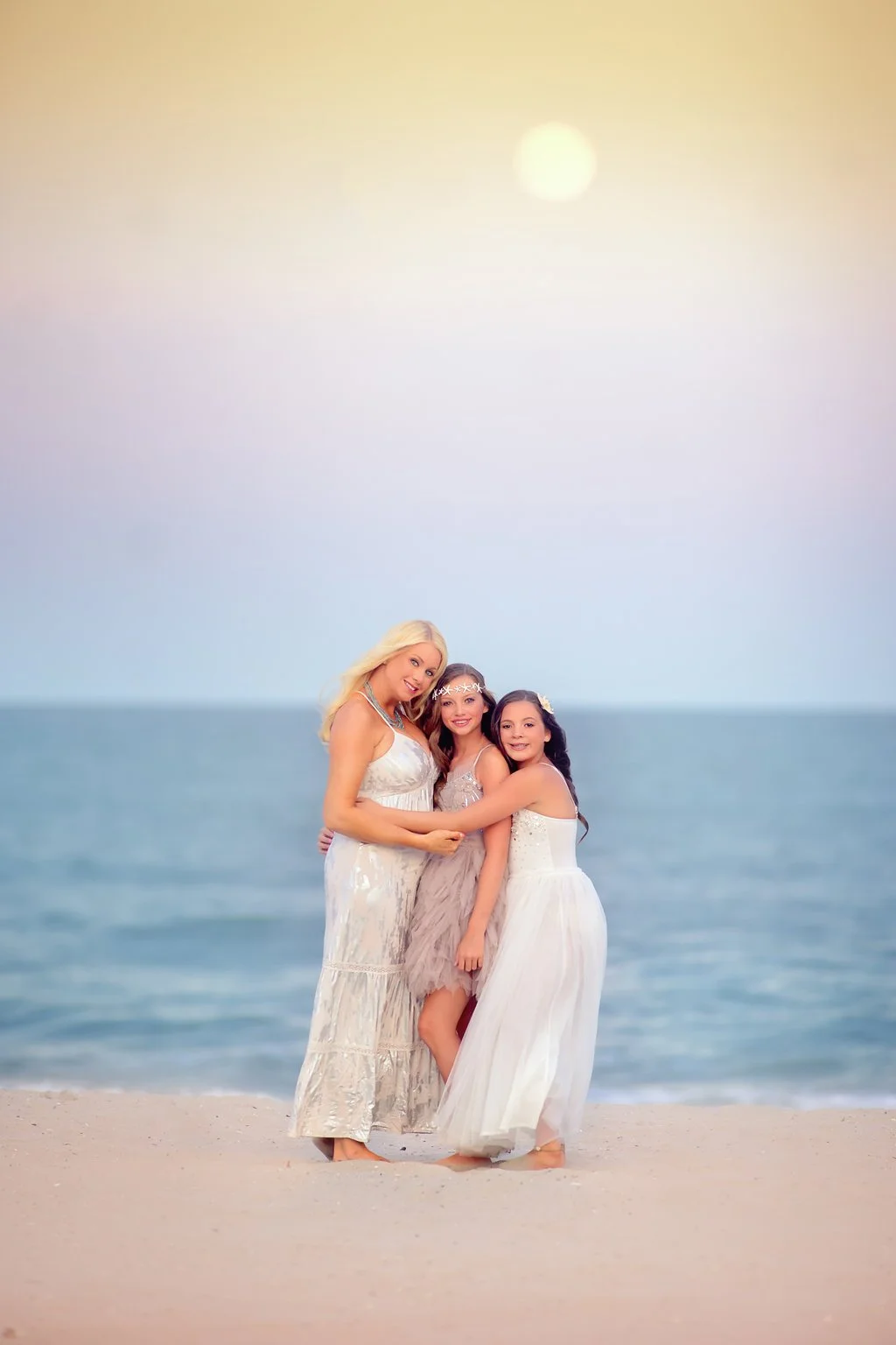 Mother with her two daughters along the beach at sunset in Brigantine, New Jersey, photographed in a soft fine art style