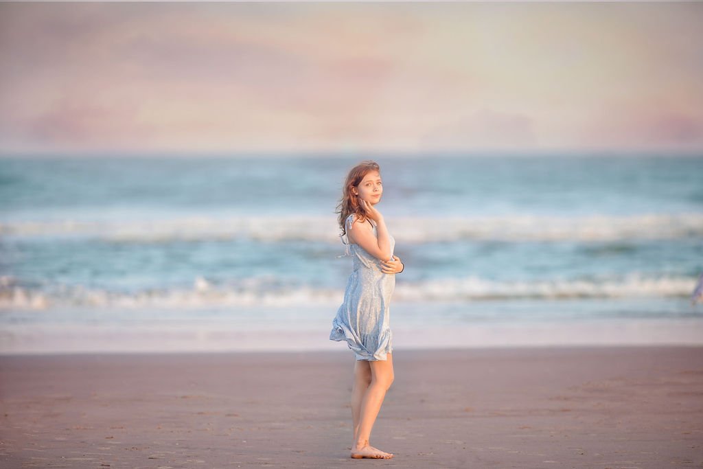 Teen girl posing by the shoreline on the beach in Wildwood NJ during a portrait session