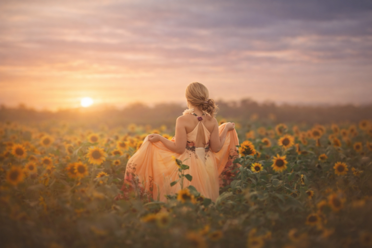Fine art portrait of a young girl in a yellow sunflower field near Philadelphia, photographed by a Greater Philadelphia family photographer