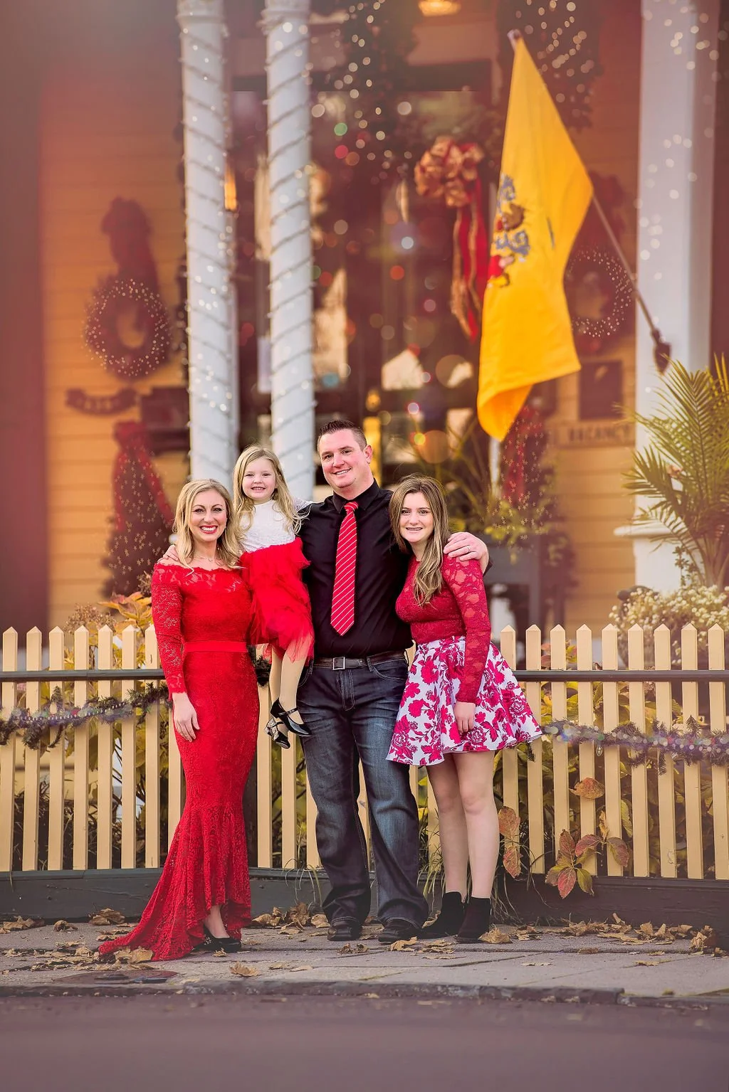 Family portrait in front of a Cape May bed and breakfast along the Jersey Shore captured by a New Jersey family photographer.