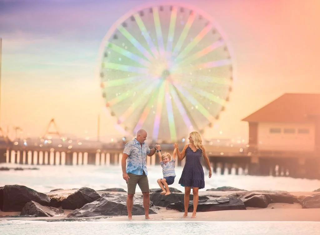 Family having fun in front of Steel Pier in Atlantic City NJ during a Jersey Shore family portrait session.