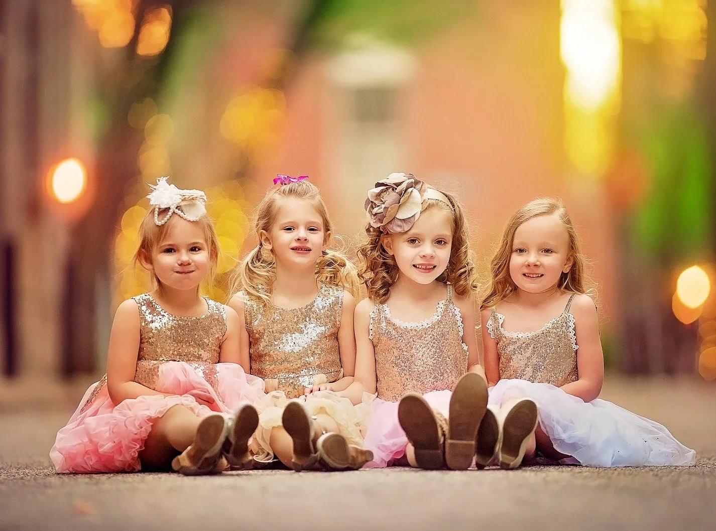 Four children posing together on a Rittenhouse Square sidewalk during a Philadelphia family portrait session.