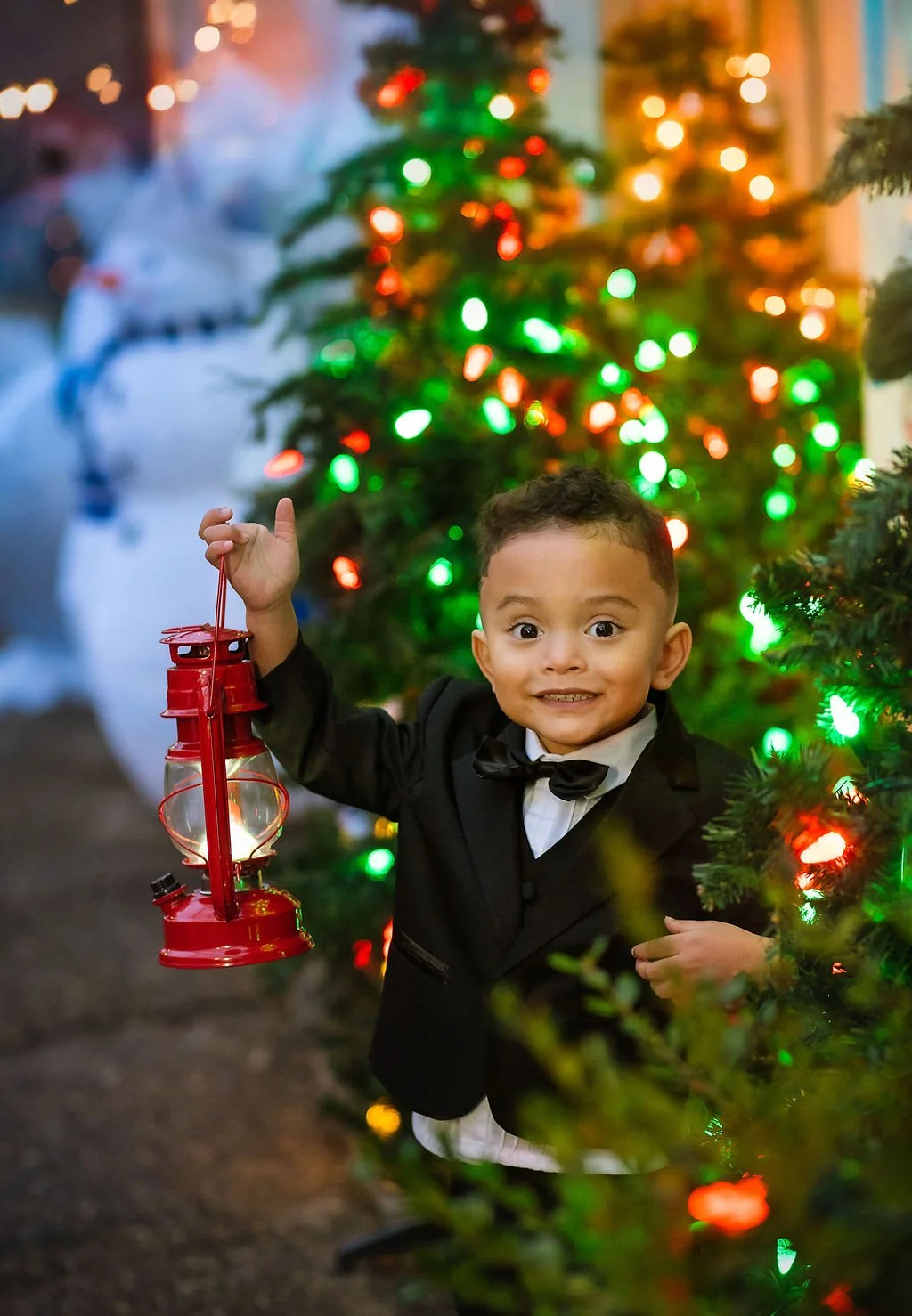 young boy holding lantern during Christmas portrait session in Philadelphia