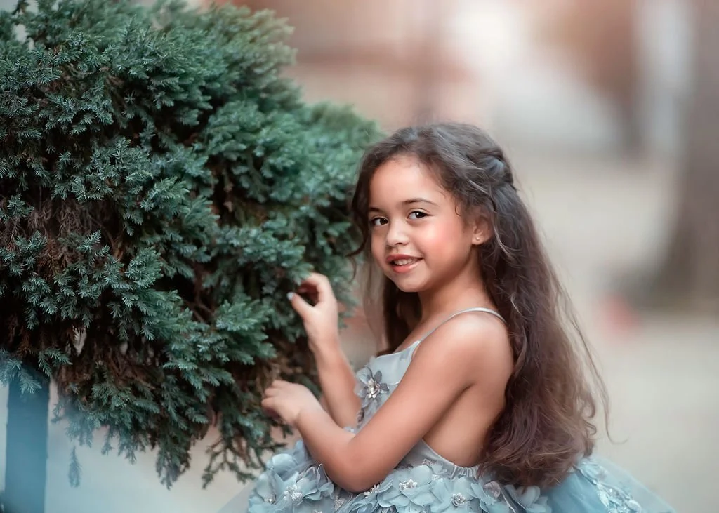 Close-up portrait of a little girl wearing a silver dress during a family session on Addison Street in Philadelphia.