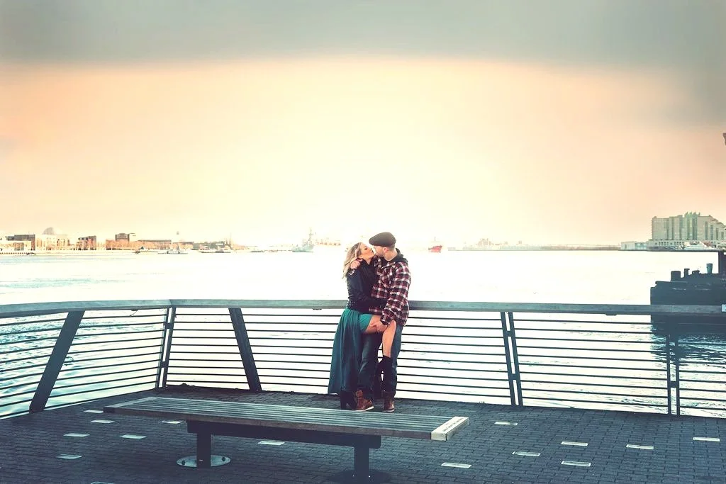 An intimate, romantic moment between Beth and her fiancé during their engagement session at Race Street Pier