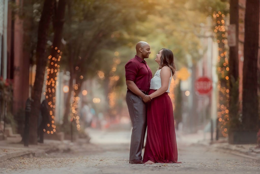 Parents gazing into each other’s eyes during a relaxed family session on Addison Street in Philadelphia.