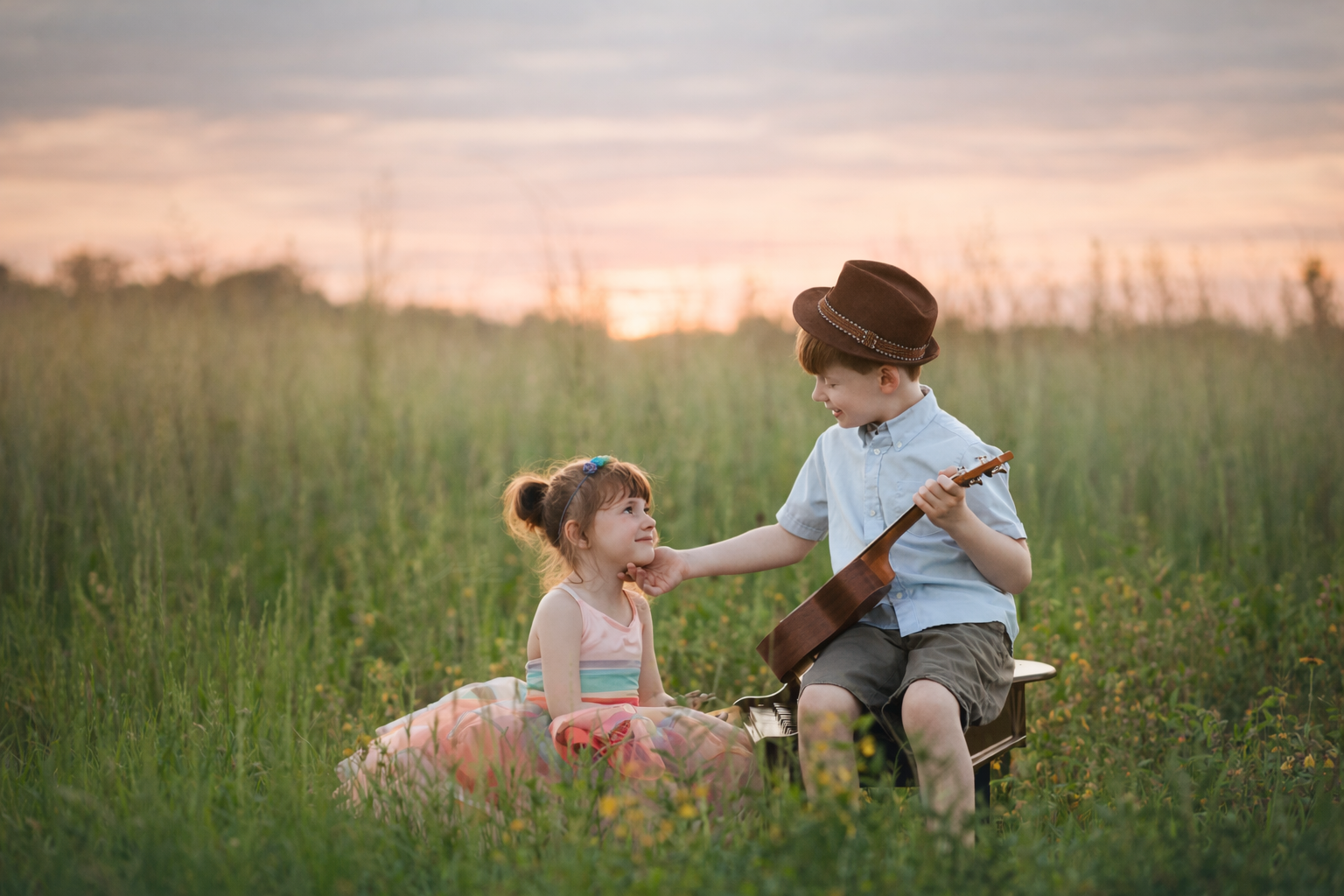 Rocco and Gigi posing together in a meadow at sunset during a fine art sibling portrait session in New Jersey.