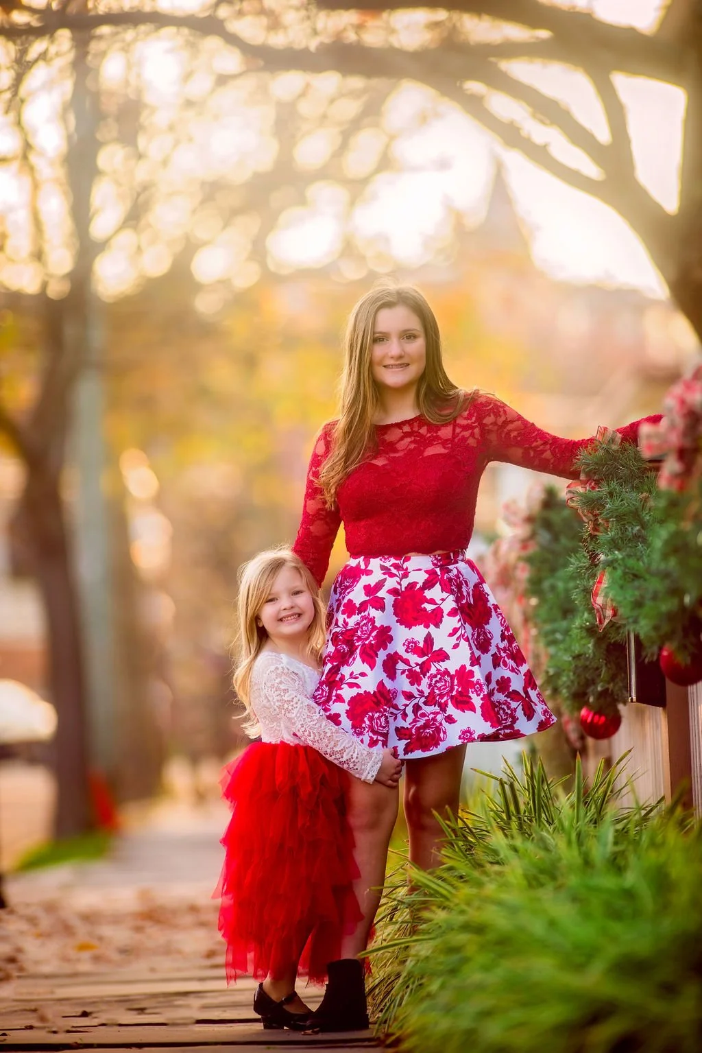 Two sisters standing together in glowing sunset backlight during a Cape May family photography session along the Jersey Shore.