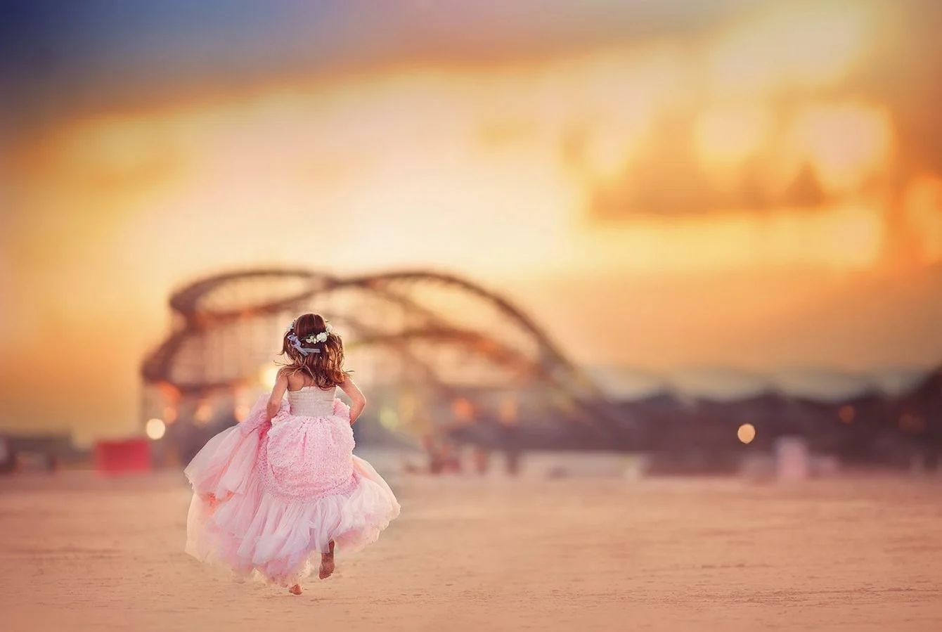 girl running on the beach in wildwood for a magical jersey shore portrait session with a photographer